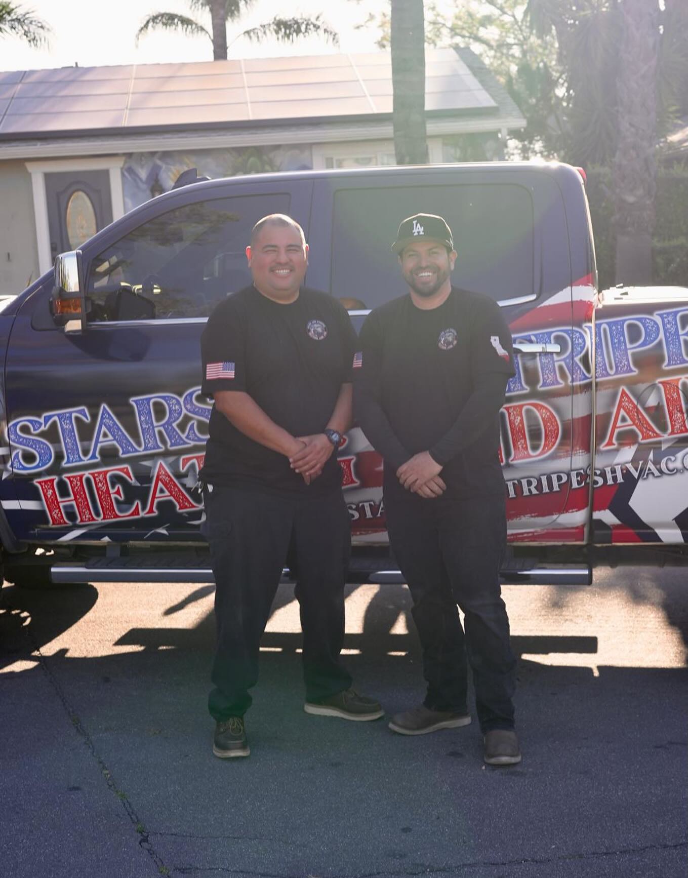 The Stars and Stripes Heating and Air team in front of a service truck